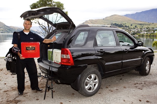 Bayleys Queenstown sales consultant Mark Martin loads up some of the sensaitonal items going up for the auction at the Michael Hill New Zealand Golf Open to raise funds for Guide Dog Services. 